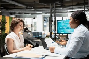 HR businesswoman explaining employee benefits contract - open enrollment guide