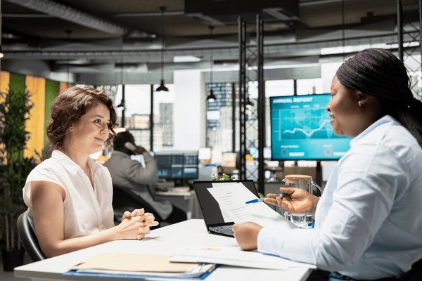 HR businesswoman explaining employee benefits contract - open enrollment guide