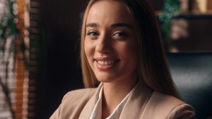 Happy smiling employee showing dental benefits - dental and vision insurance
