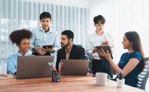 Happy diverse business team working together - small business payroll growth